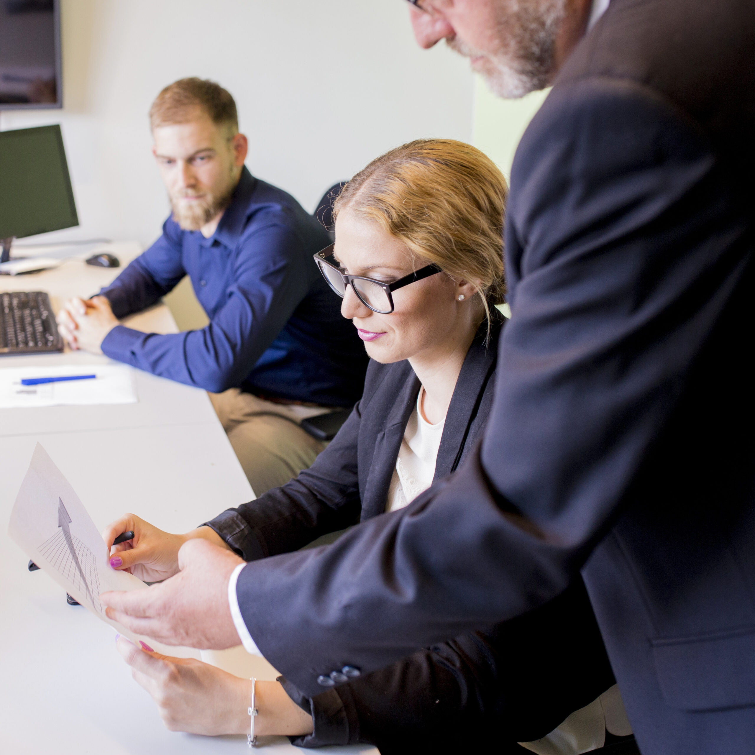 close-up-businessman-showing-business-report-female-colleague