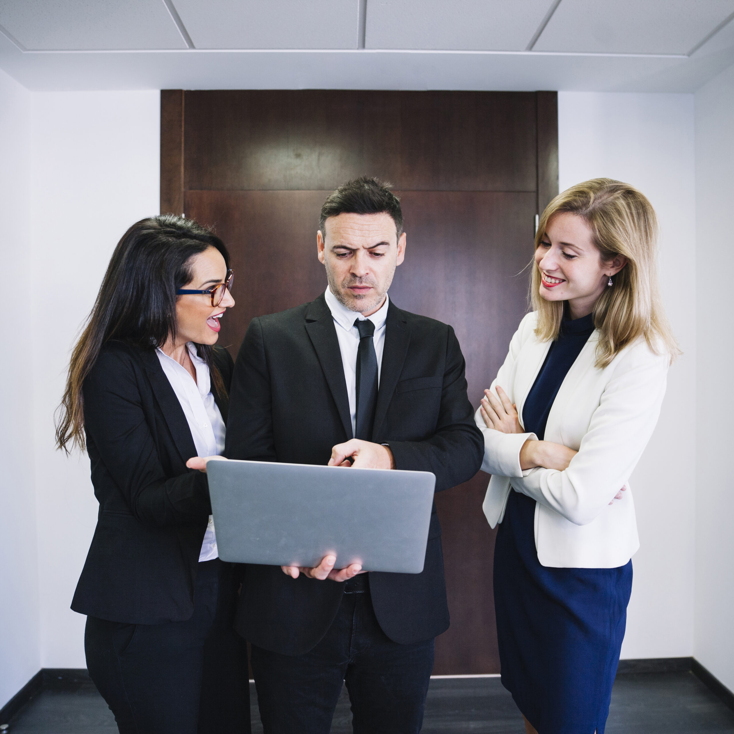 corporate-business-people-looking-laptop